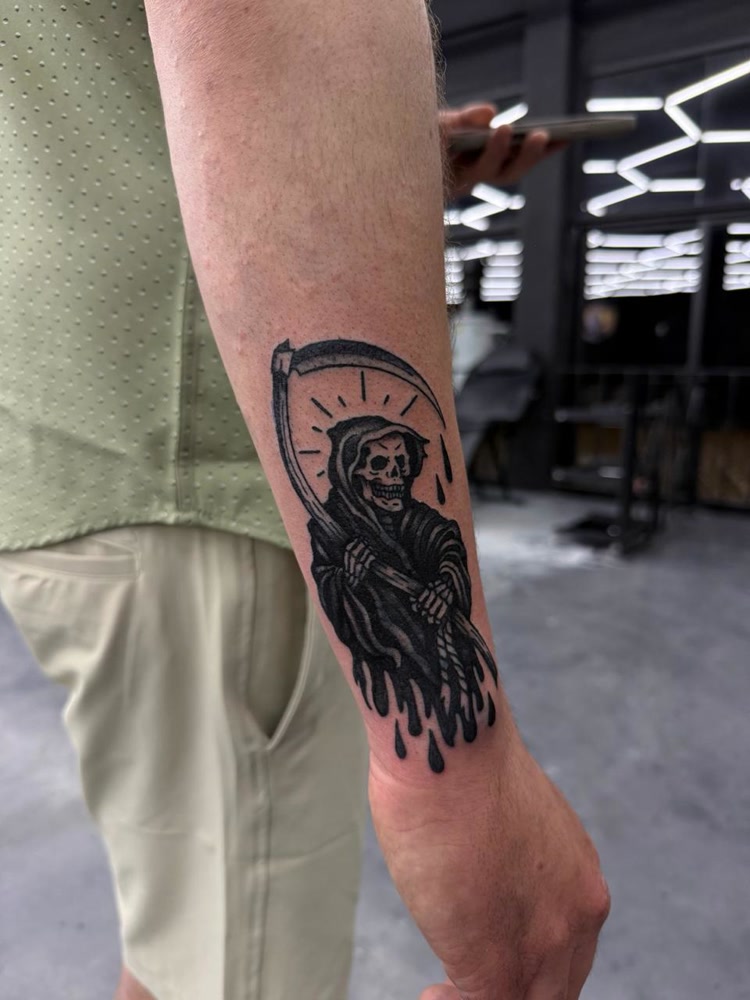 Grim reaper traditional blackwork forearm